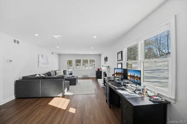 a kitchen with a sink and wooden floor