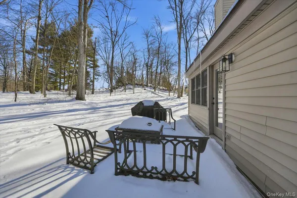 a roof deck with table and chairs and wooden floor