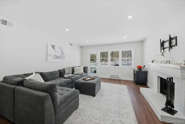 a living room with furniture a fireplace and a flat screen tv