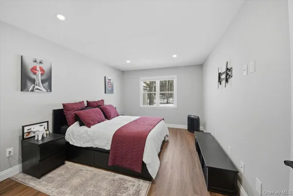 a bed room with a bed and a painting