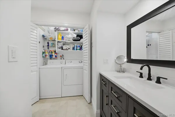 a utility room with sink dryer and washer