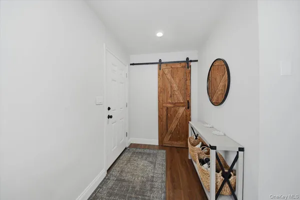 a view of a room with rack and wooden door