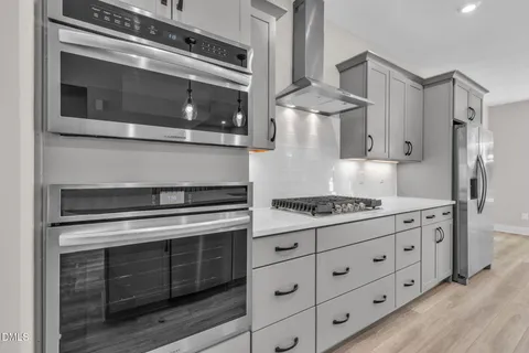 a view of a kitchen with a stove cabinets and wooden floor