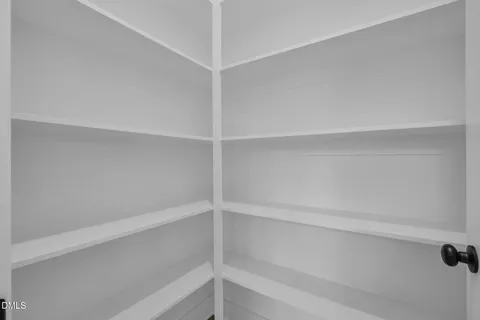 a kitchen with stainless steel appliances granite countertop a refrigerator a sink dishwasher a oven with white cabinets and wooden floor