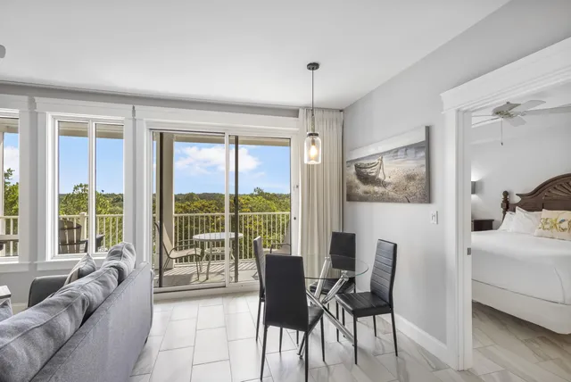 a living room with furniture and a floor to ceiling window