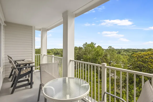 a view of a balcony with a table and chairs