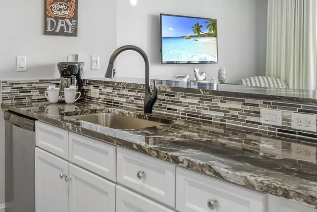a kitchen with sink and a stove