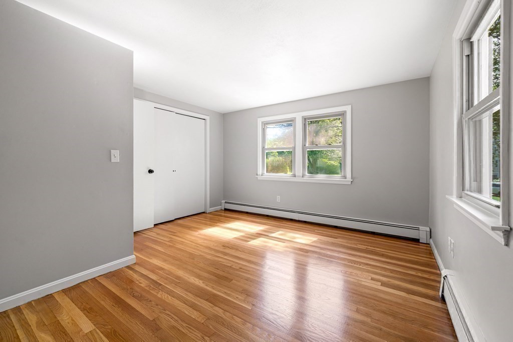6 Coleman Road Groveland, MA 01834 - Photo 19 of 39 an empty room with wooden floor and windows