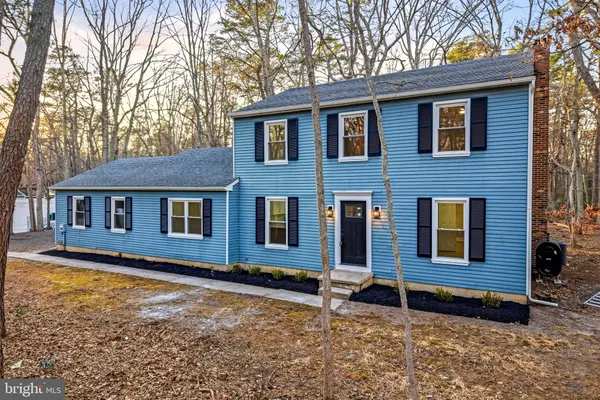 a front view of a house with yard