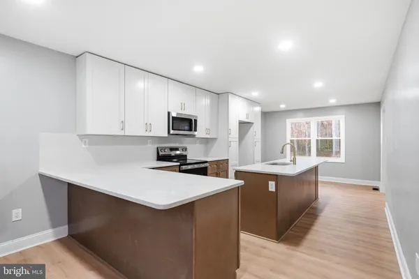 a kitchen that has a sink and a stove in it
