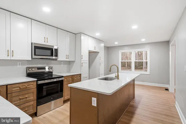 a kitchen with sink cabinets and refrigerator
