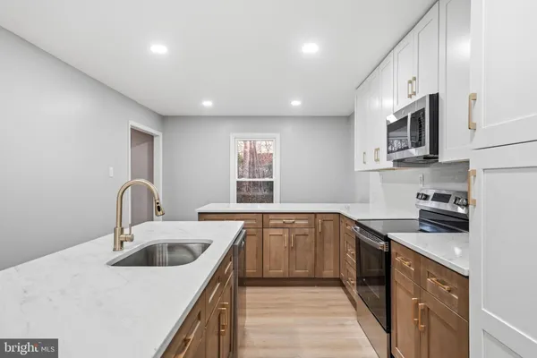 a kitchen that has a sink and a stove top oven