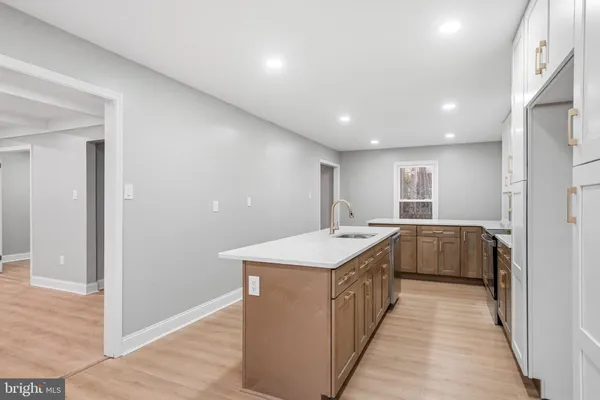 a kitchen with a sink and natural light