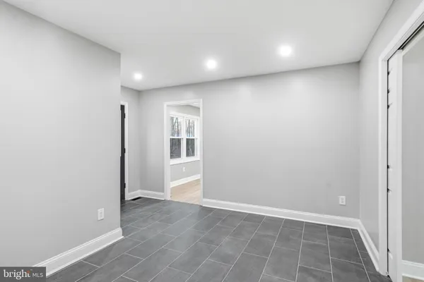 an empty room with windows and closet