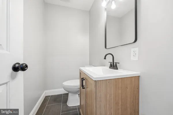 a bathroom with a toilet sink and mirror