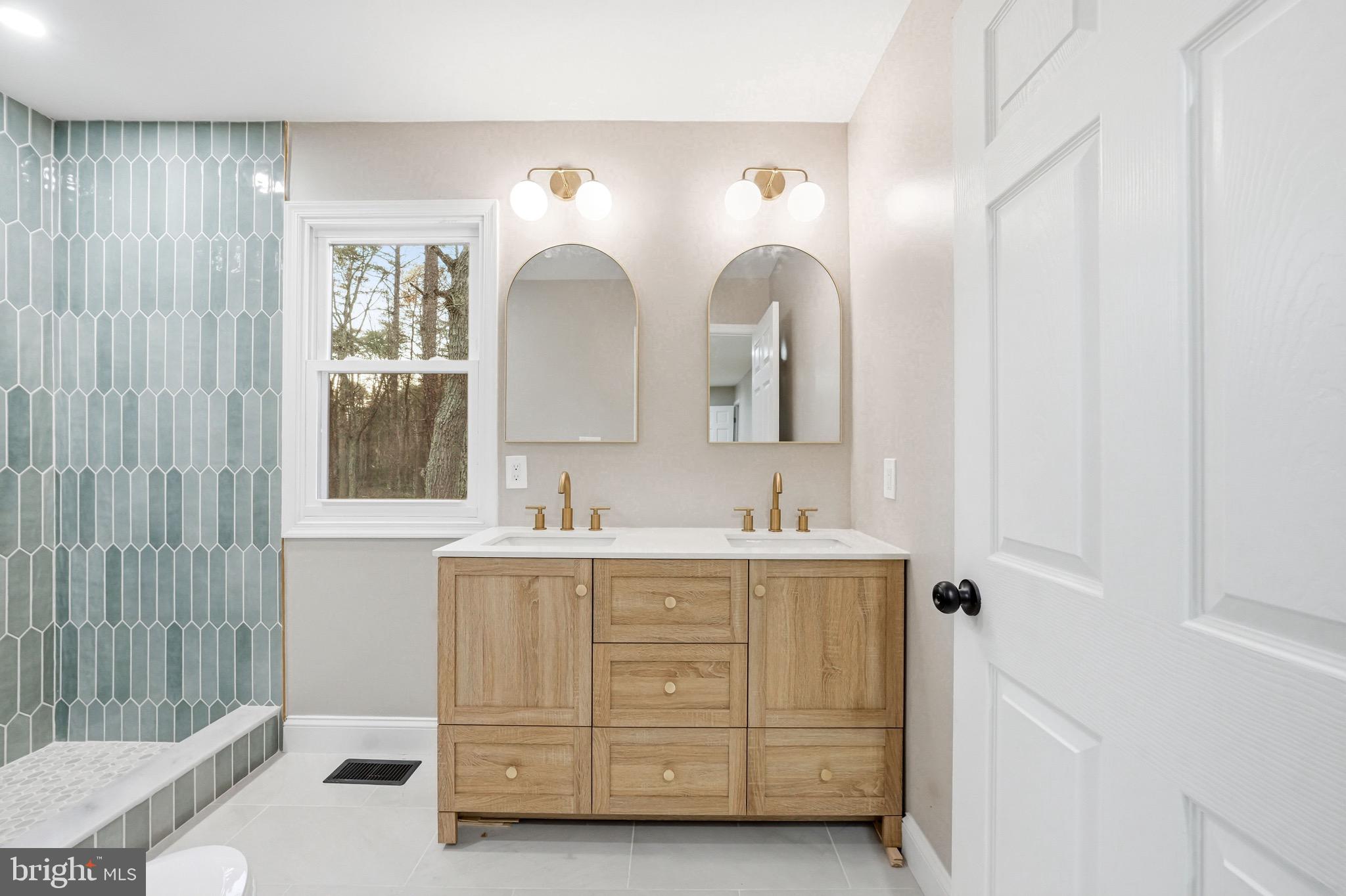18 Waltham Drive Tabernacle, NJ 08088 - Photo 34 of 43 a en suite bathroom with double vanity a mirror a vanity and a shower