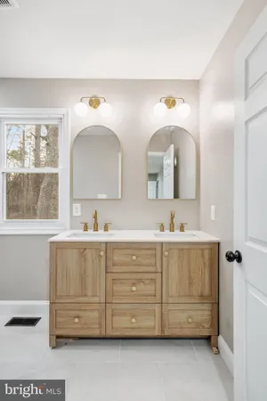 a bathroom with a double vanity sink mirror and