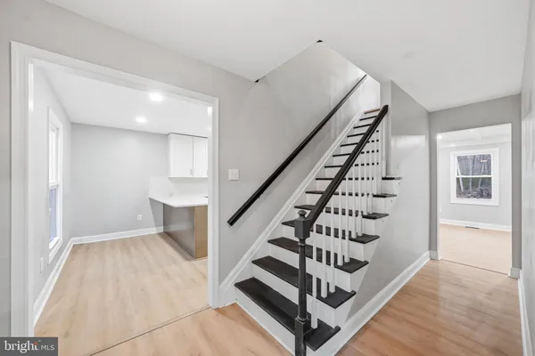 a view of an entryway with wooden floor and windows