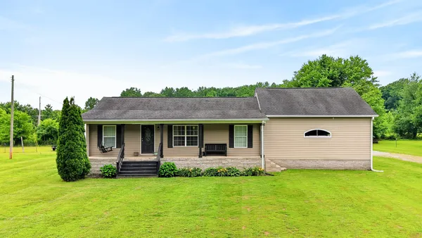 a front view of house with yard and green space