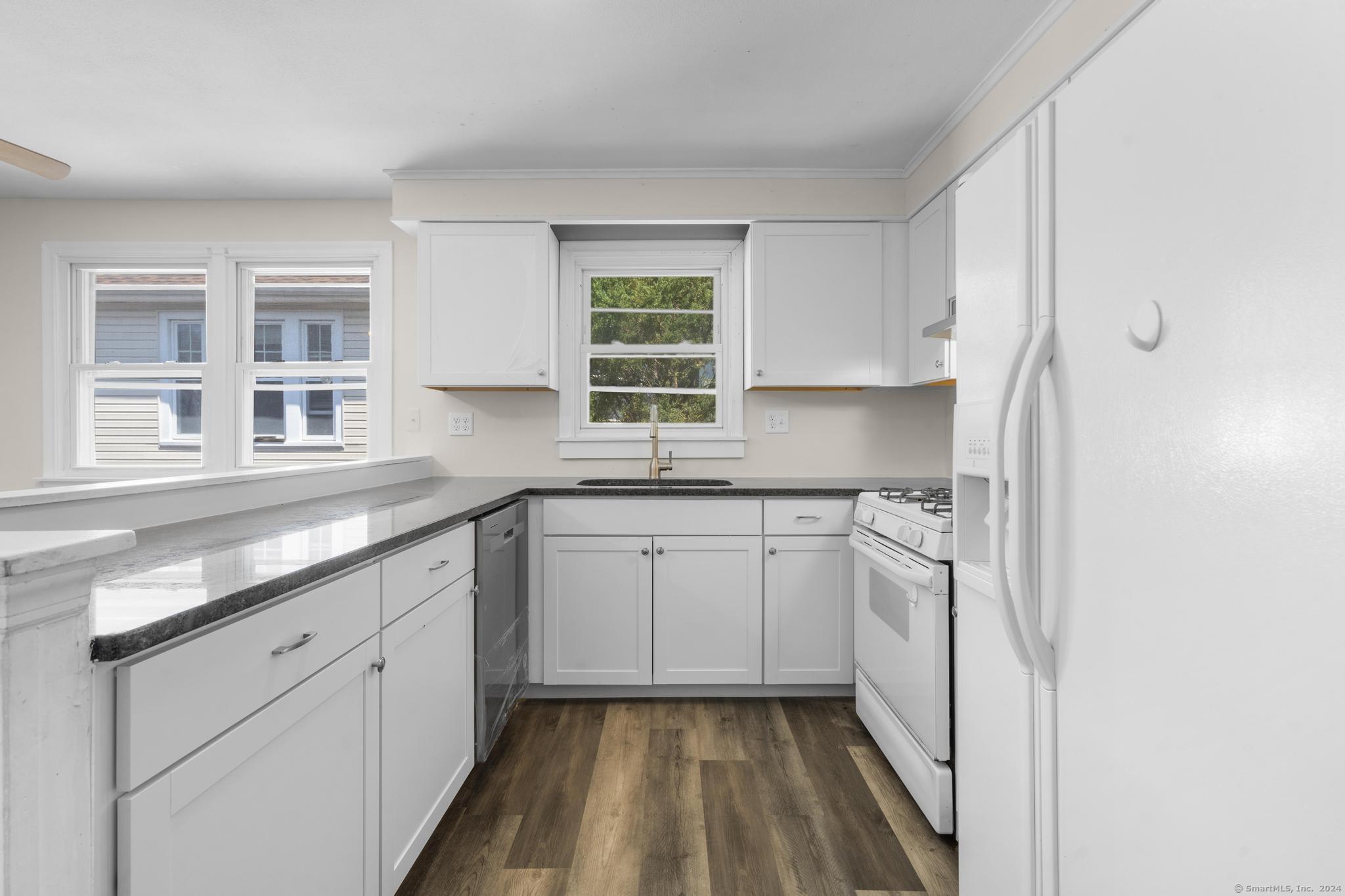 a kitchen with a sink window and cabinets
