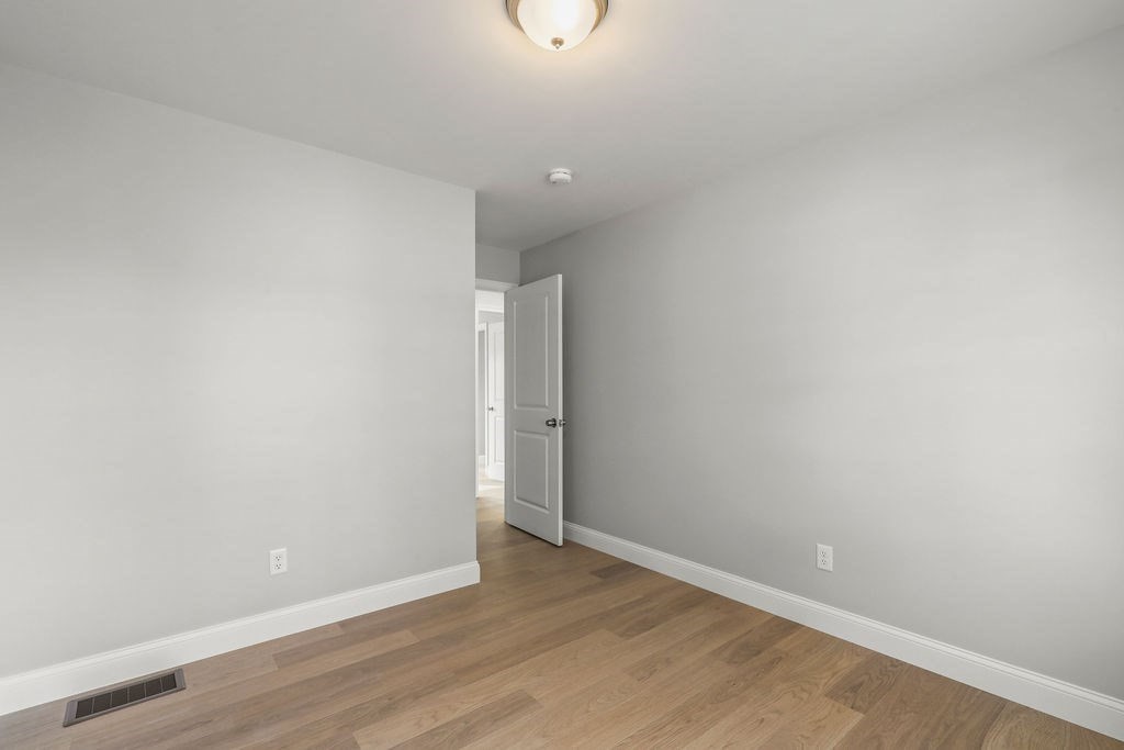 81 Maple Springs Road Wareham, MA 02571 - Photo 11 of 17 a view of an empty room with wooden floor