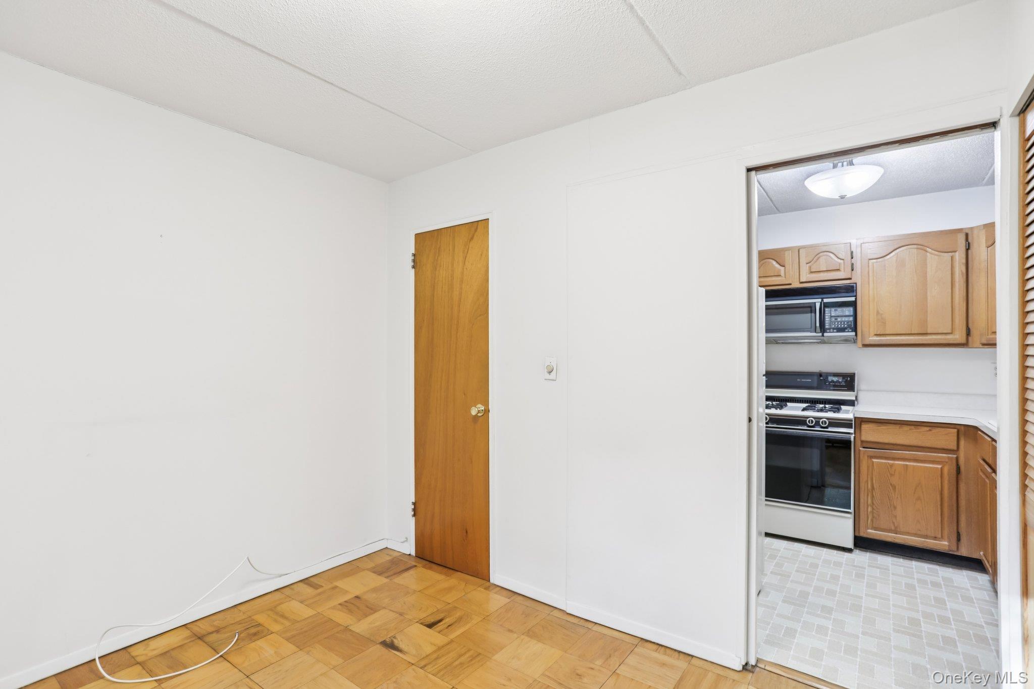 108 Sagamore Road, Unit 3E Tuckahoe, NY 10707 - Photo 12 of 30 a view of a kitchen with a sink and a refrigerator