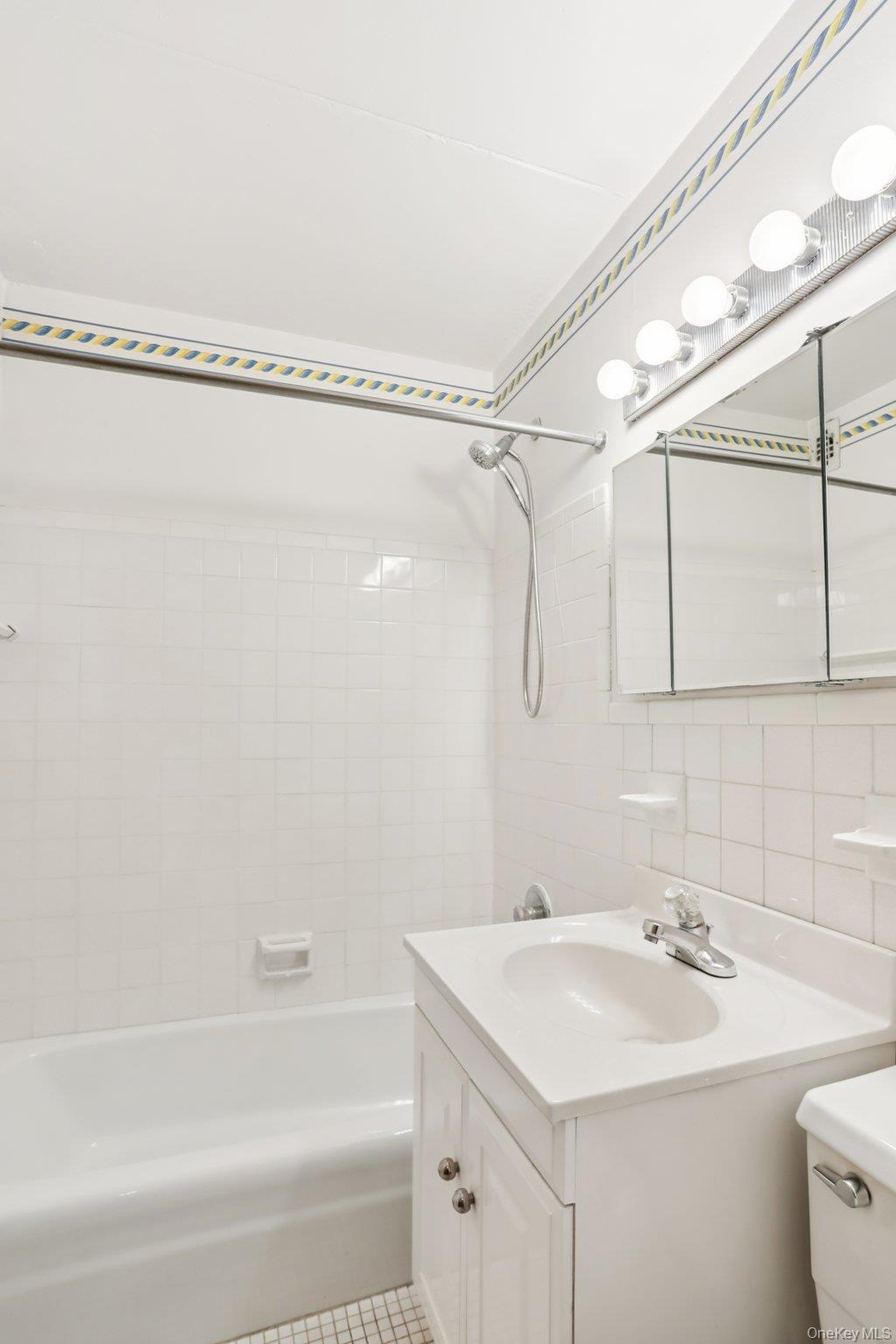 108 Sagamore Road, Unit 3E Tuckahoe, NY 10707 - Photo 22 of 30 a bathroom with a sink a mirror and a bathtub