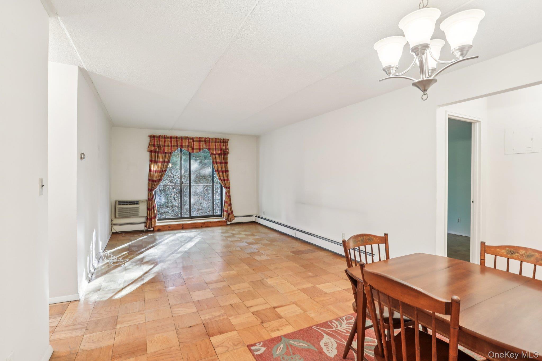 108 Sagamore Road, Unit 3E Tuckahoe, NY 10707 - Photo 8 of 30 a view of a room with a chandelier fan and wooden floor