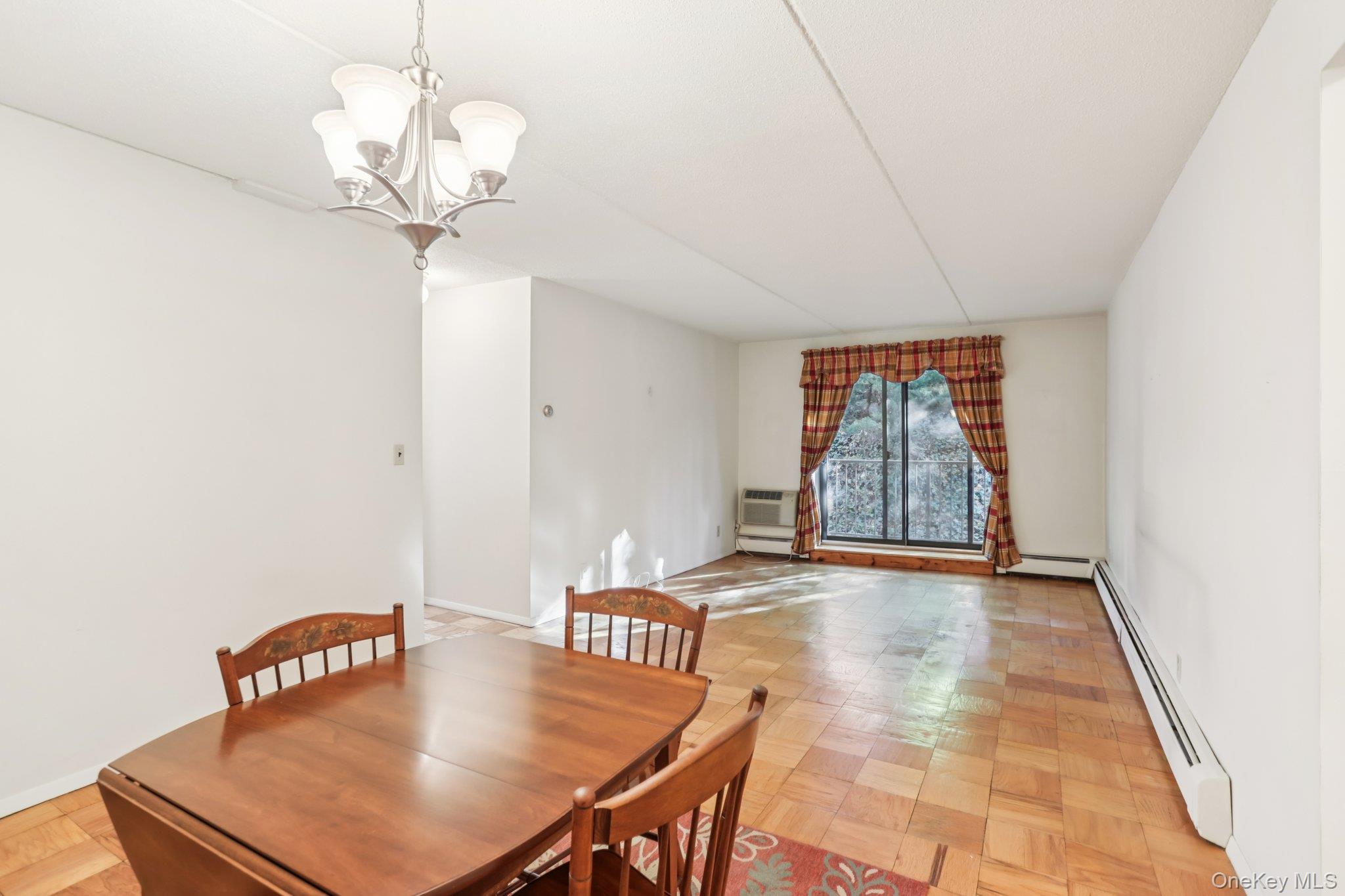 108 Sagamore Road, Unit 3E Tuckahoe, NY 10707 - Photo 9 of 30 a view of a room with a table and chandelier
