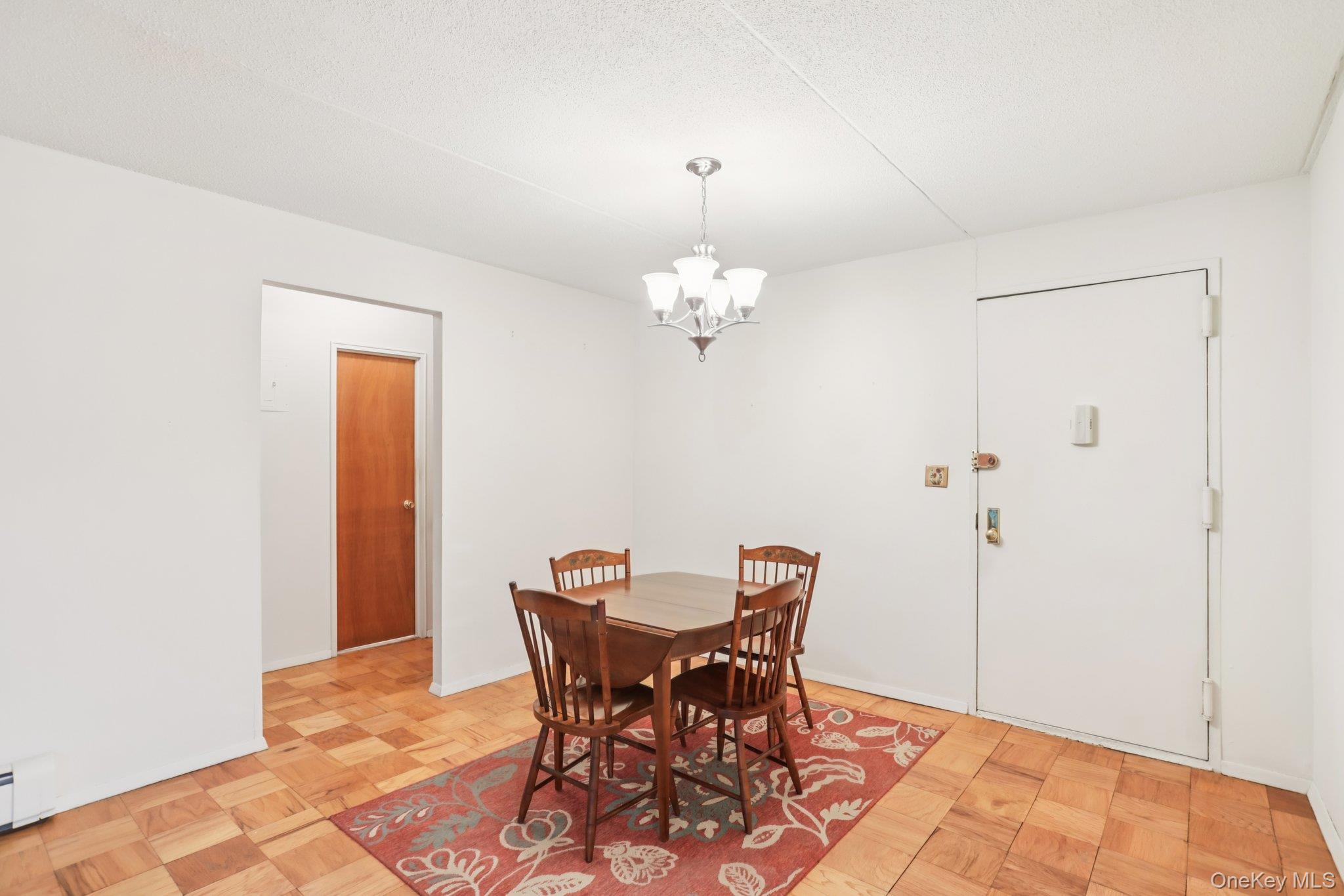 108 Sagamore Road, Unit 3E Tuckahoe, NY 10707 - Photo 10 of 30 a view of a dining room with furniture and chandelier