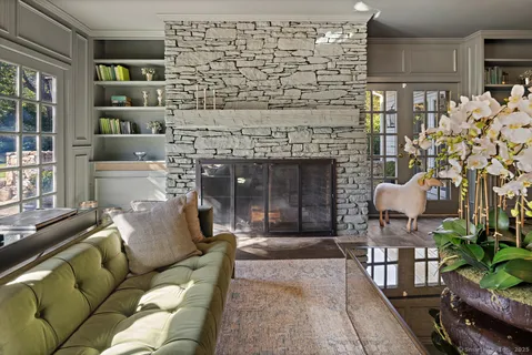 a living room with furniture a flat screen tv and a fireplace