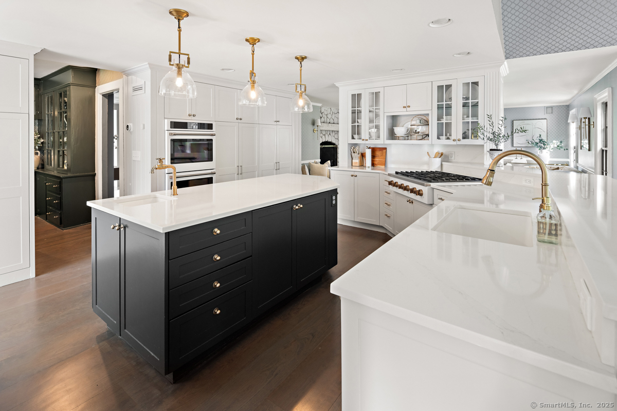 469 Brookside Road New Canaan, CT 06840 - Photo 14 of 40 a kitchen with stainless steel appliances kitchen island granite countertop a sink a stove and a refrigerator