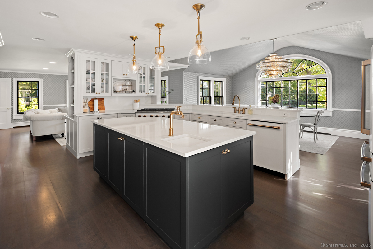 469 Brookside Road New Canaan, CT 06840 - Photo 15 of 40 a large kitchen with kitchen island a sink a counter space appliances and a window