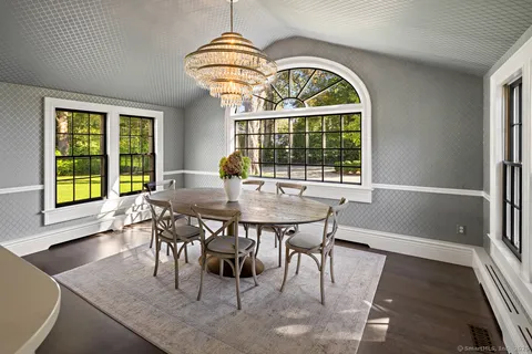 a living room with furniture a fireplace and a table