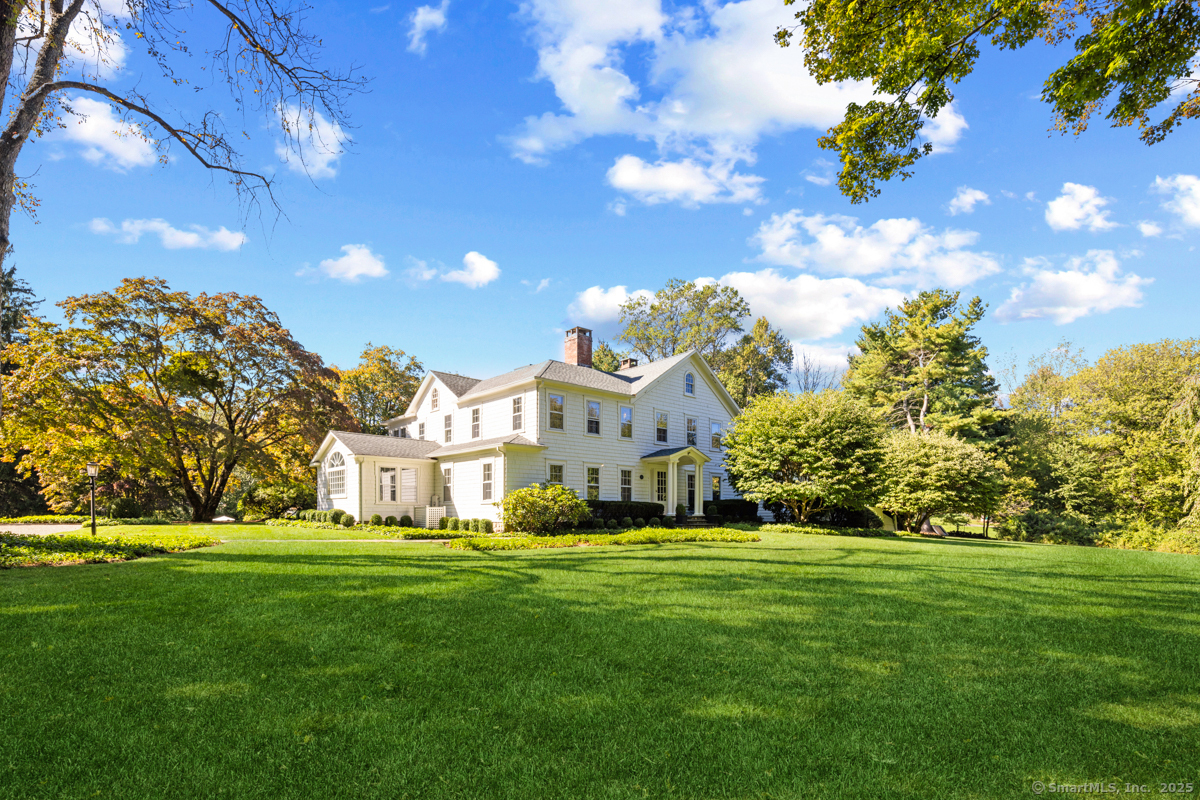 469 Brookside Road New Canaan, CT 06840 - Photo 2 of 40 a front view of a house with a garden