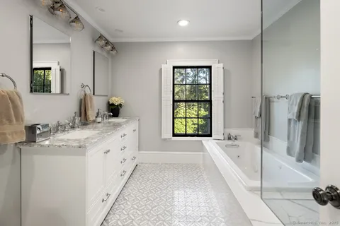 a spacious bedroom with a bed and a large window