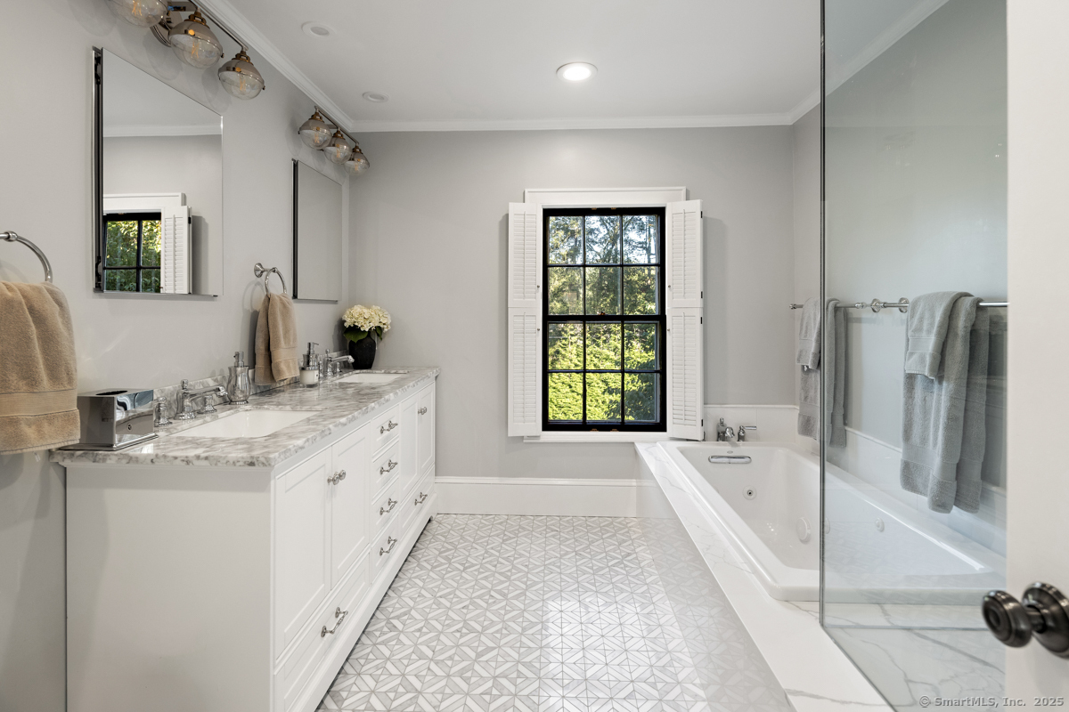 469 Brookside Road New Canaan, CT 06840 - Photo 21 of 40 a spacious bathroom with a tub sink and mirror