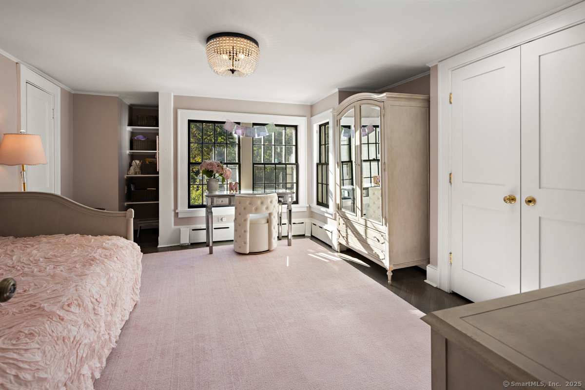 469 Brookside Road New Canaan, CT 06840 - Photo 22 of 40 a spacious bedroom with a bed and a large window