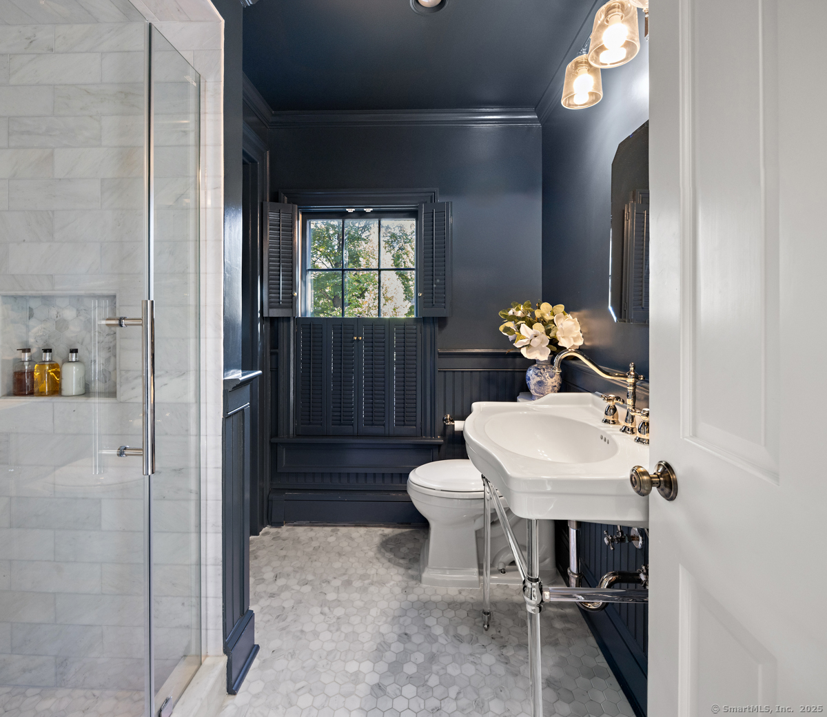 469 Brookside Road New Canaan, CT 06840 - Photo 24 of 40 a bathroom with a sink a toilet and a mirror