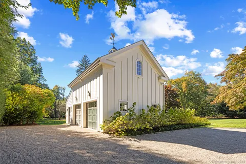 a bedroom with a bed a couch and a chandelier