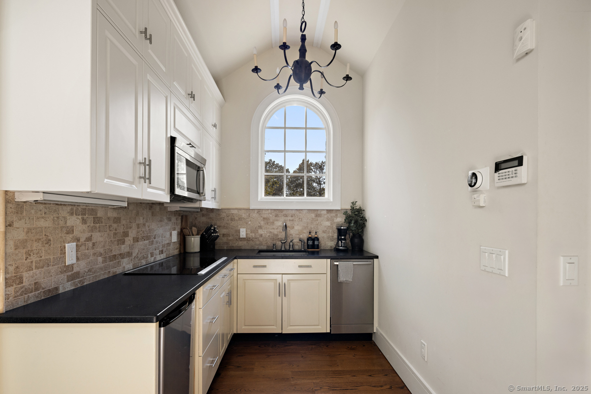 469 Brookside Road New Canaan, CT 06840 - Photo 27 of 40 a kitchen with a sink cabinets and window