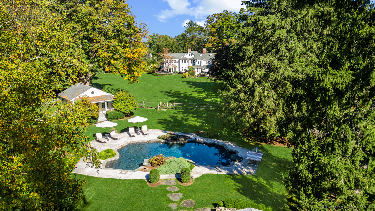 469 Brookside Road New Canaan, CT 06840 - Photo 34 of 40 a backyard of a house with lots of green space