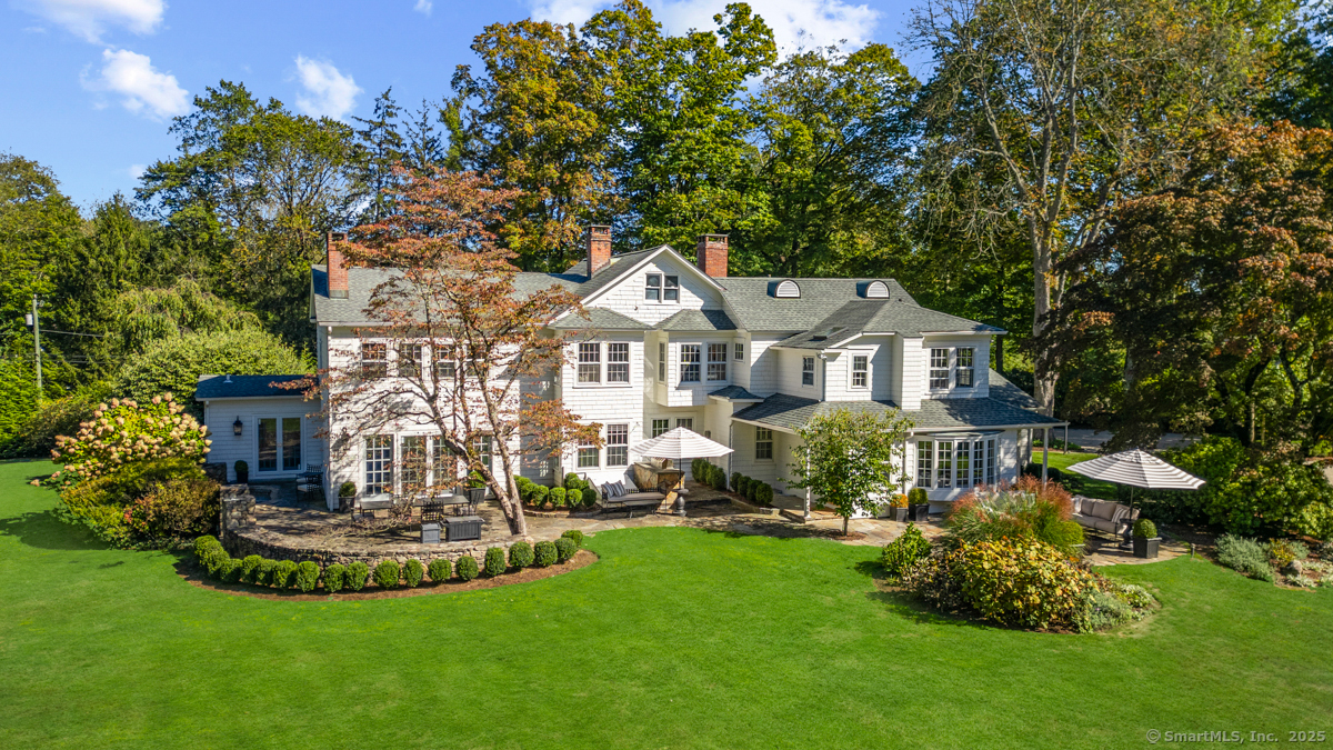 469 Brookside Road New Canaan, CT 06840 - Photo 35 of 40 a front view of a house with a garden