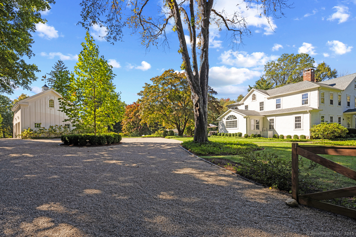 469 Brookside Road New Canaan, CT 06840 - Photo 39 of 40 a view of a yard and front view of a house