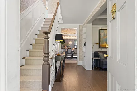 a living room with fireplace furniture and a large window
