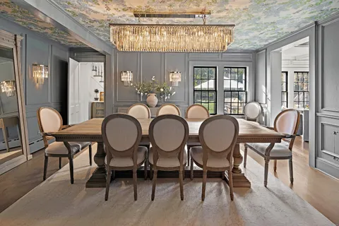 a view of a dining room with furniture and chandelier