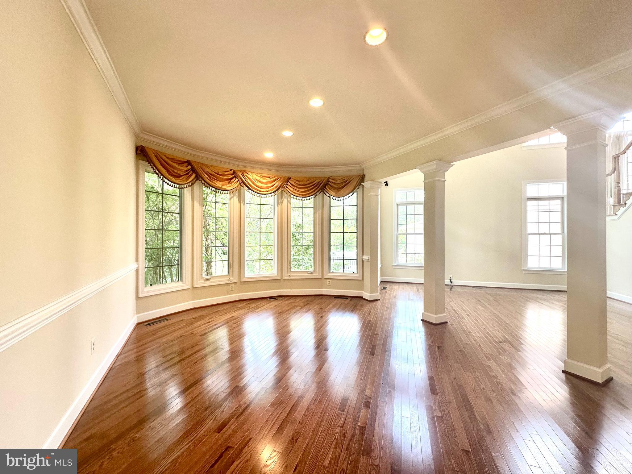 1460 Carrington Ridge Lane Vienna, VA 22182 - Photo 11 of 74 a view of an empty room with wooden floor and a window