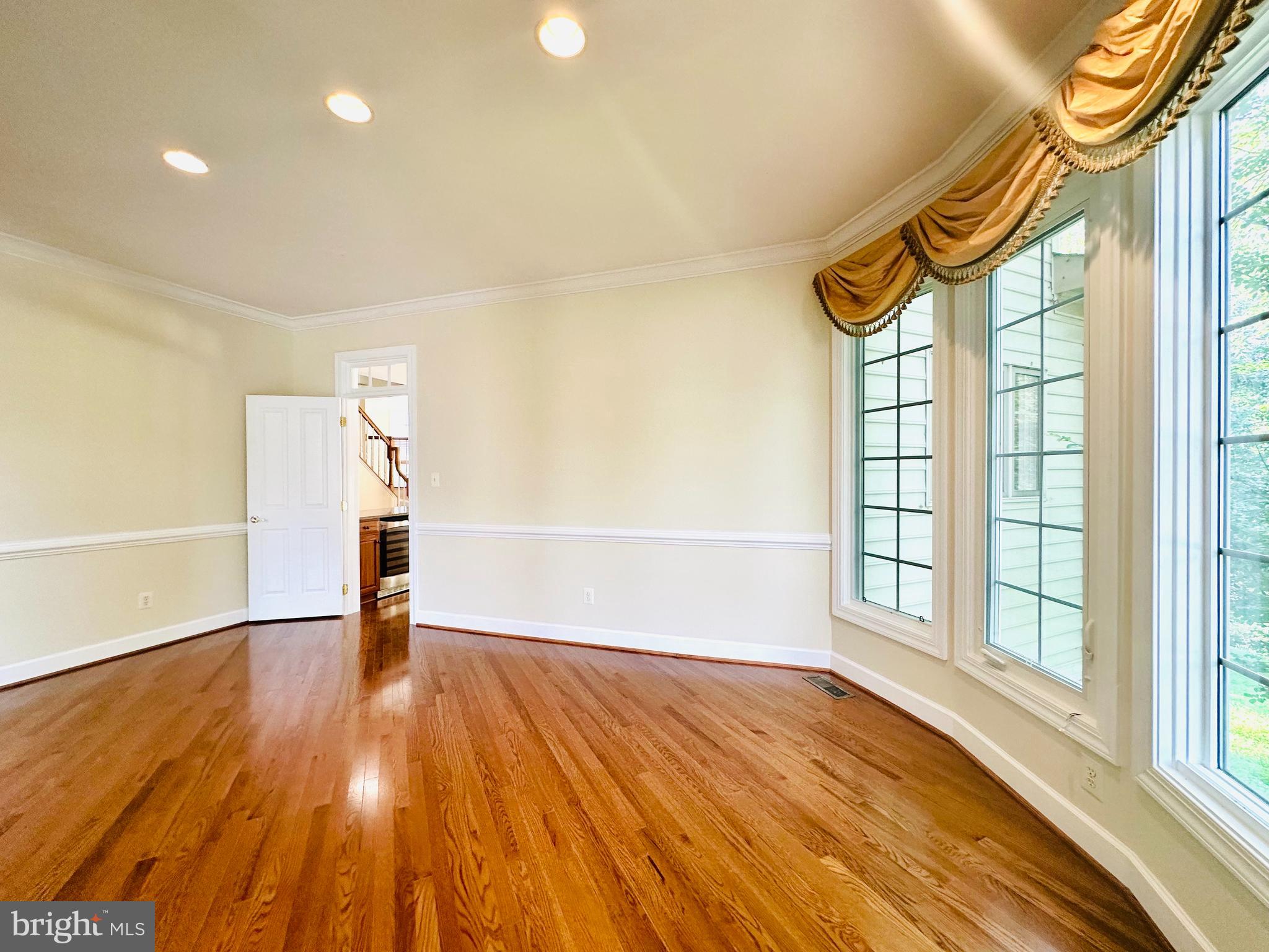 1460 Carrington Ridge Lane Vienna, VA 22182 - Photo 13 of 74 a view of an empty room with a window and wooden floor