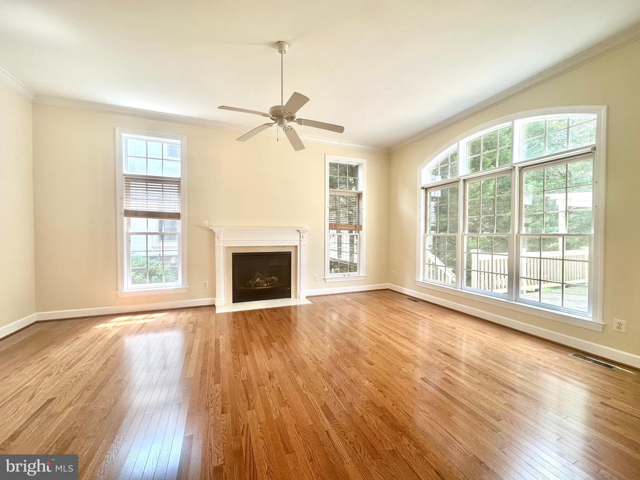 1460 Carrington Ridge Lane Vienna, VA 22182 - Photo 20 of 74 a view of an empty room with wooden floor fireplace and a window
