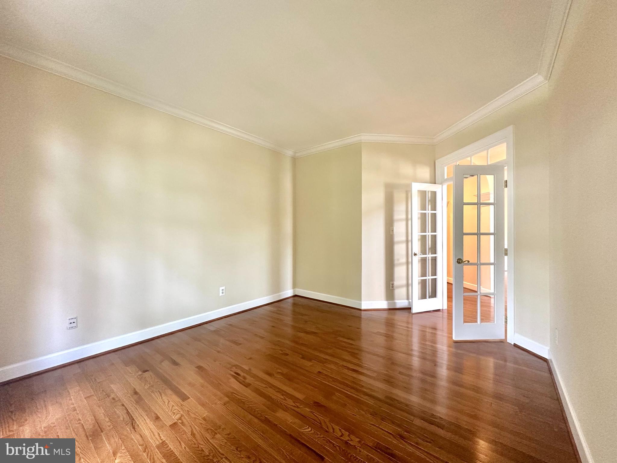 1460 Carrington Ridge Lane Vienna, VA 22182 - Photo 25 of 74 a view of an empty room with wooden floor and a window